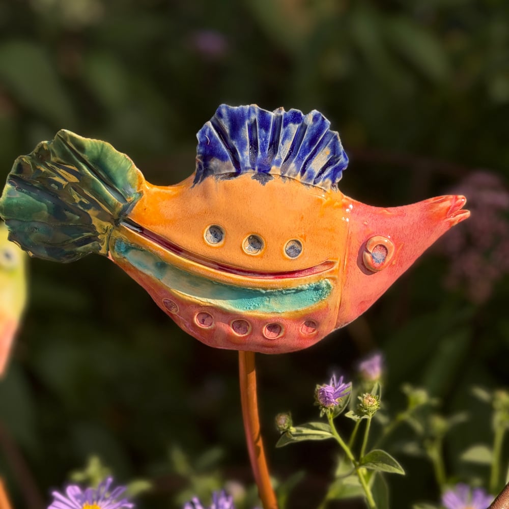Tropical fish "Grace", glazed in bright colours, sitting on a copper rod