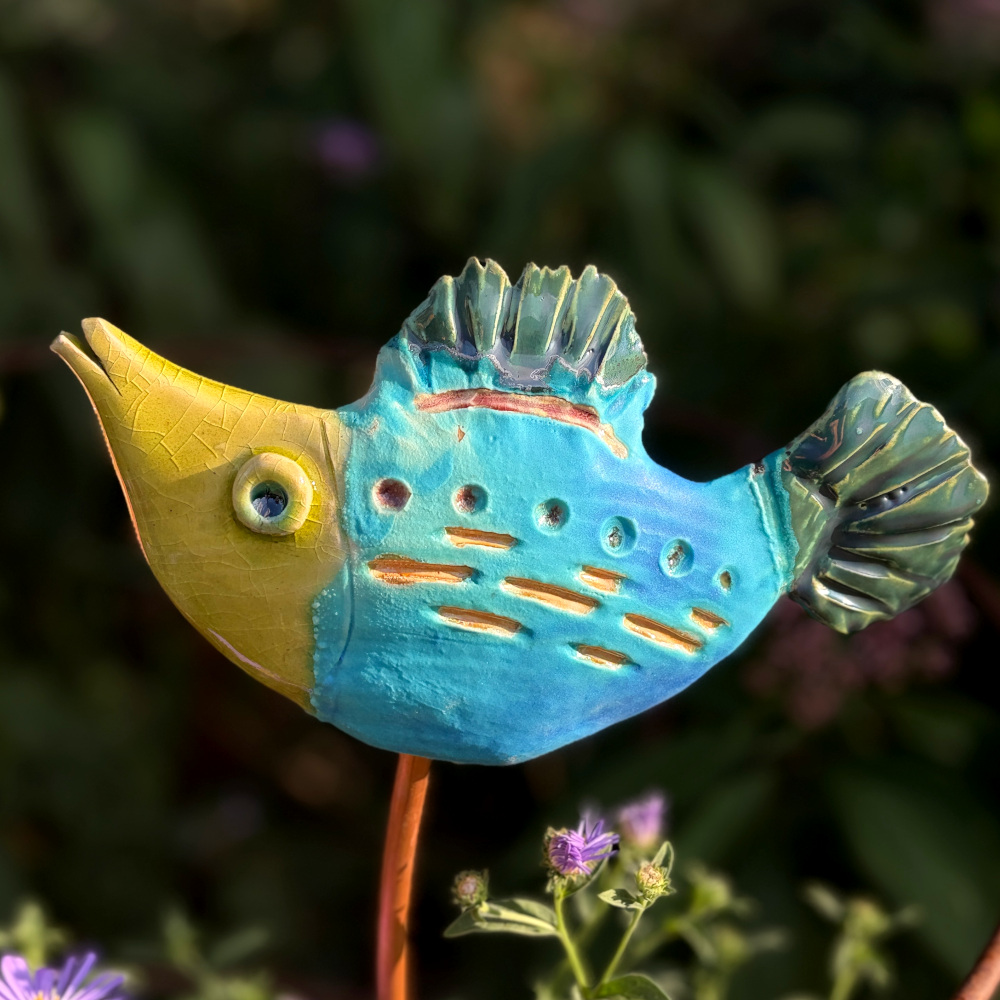 Tropical fish "Herbert", glazed in bright colours, sitting on a copper rod