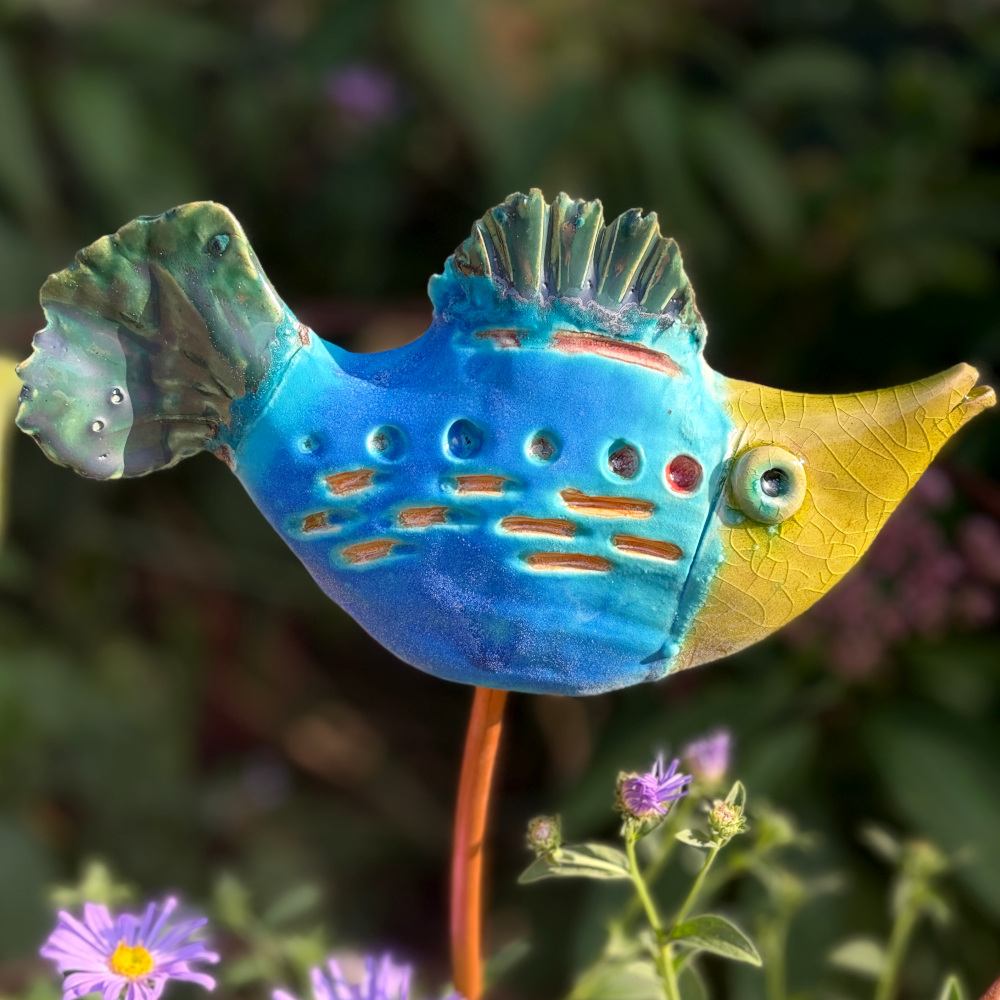 Tropical fish "Herbert", glazed in bright colours, sitting on a copper rod