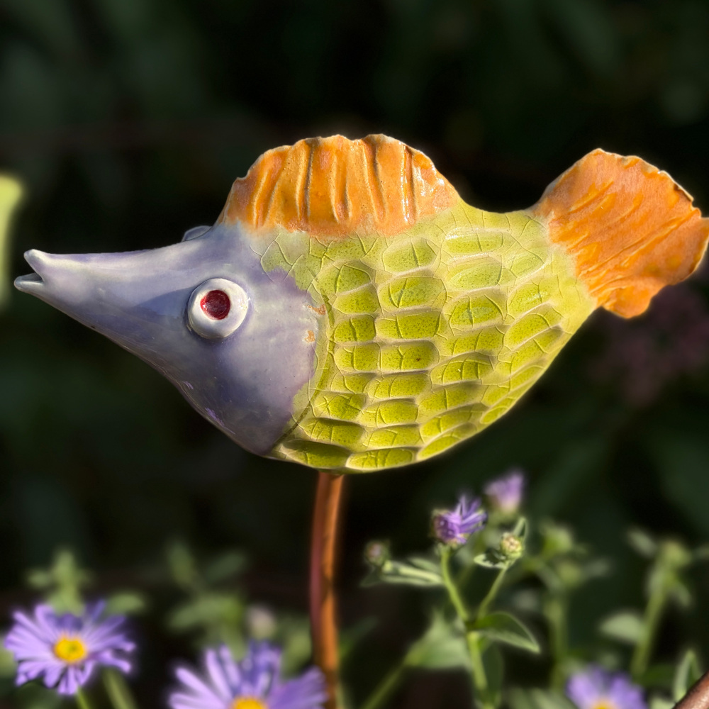 Tropical fish "Jim", glazed in bright colours, sitting on a copper rod