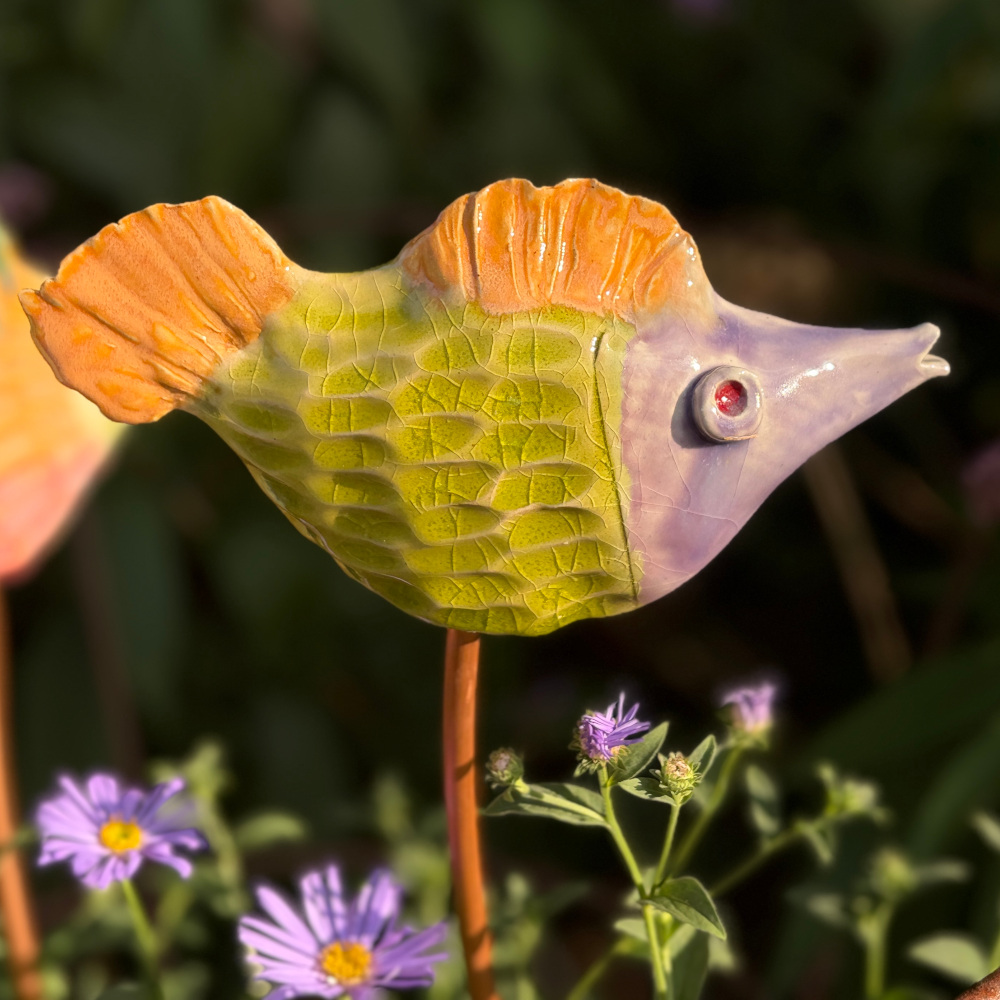 Tropical fish "Jim", glazed in bright colours, sitting on a copper rod