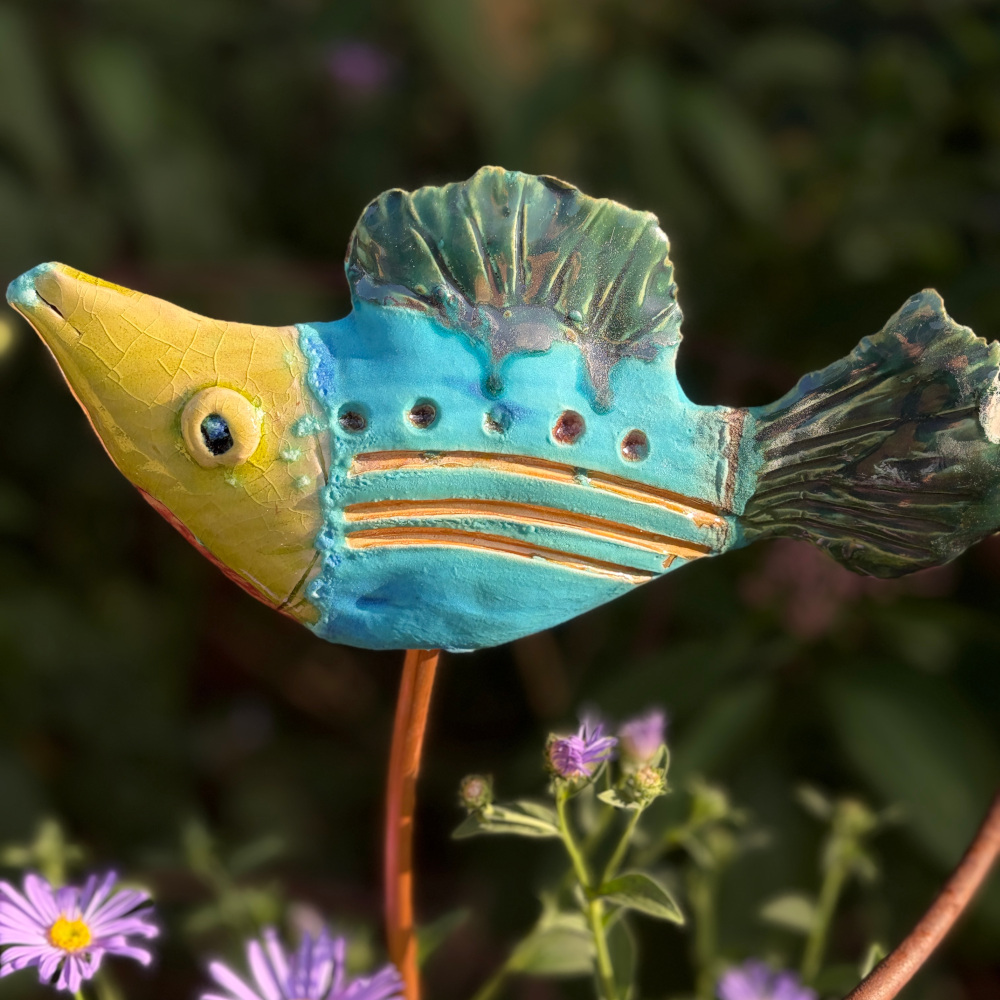 Tropical fish "Paul", glazed in bright colours, sitting on a copper rod