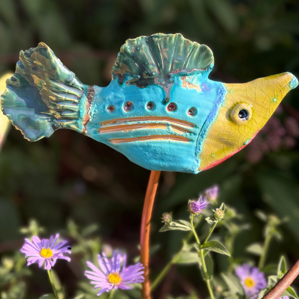 Tropical fish "Paul", glazed in bright colours, sitting on a copper rod