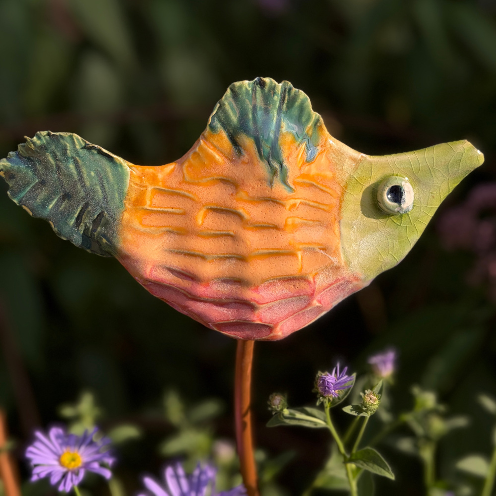 Tropical fish "Petra", glazed in bright colours, sitting on a copper rod
