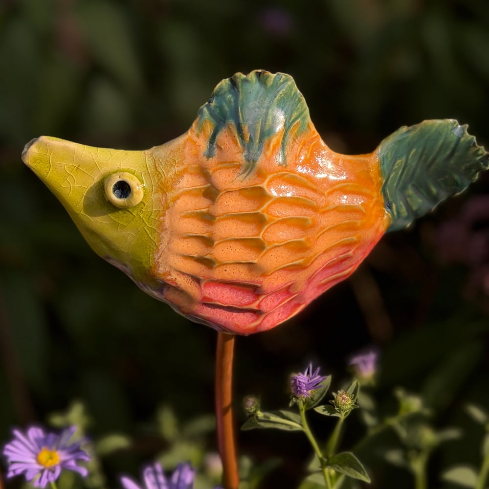 Tropical fish "Petra", glazed in bright colours, sitting on a copper rod