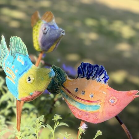 a group of ceramic fish glazed in tropical colours