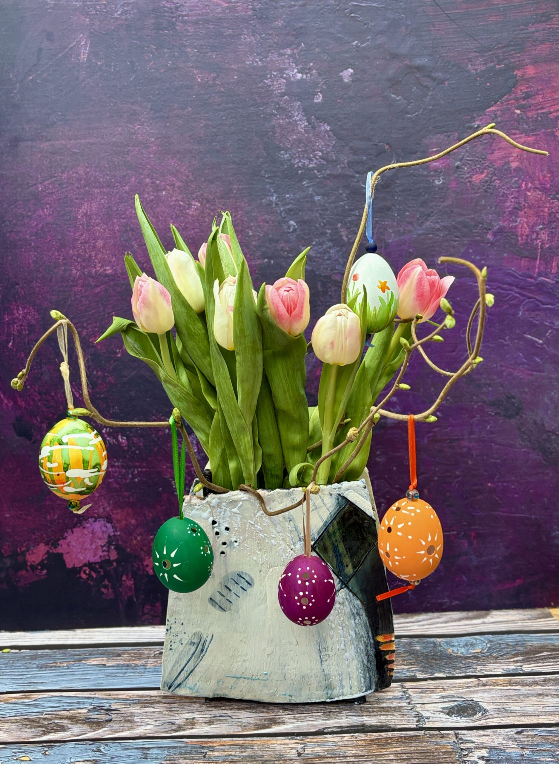 Rectangular slab built vase, decorated with engobes, wax crayons, ceramic ink;with tulips and Easter eggs
