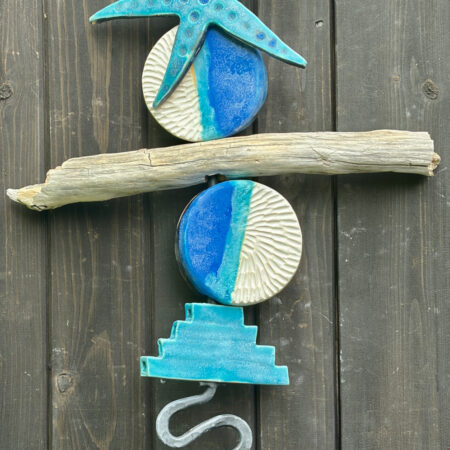 Tideline with large ceramic starfish, ceramic elements and driftwood