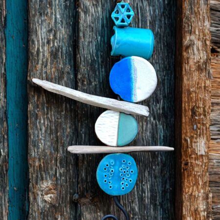Tidelines, a mixture of ceramics and driftwood assembled on a metal rod