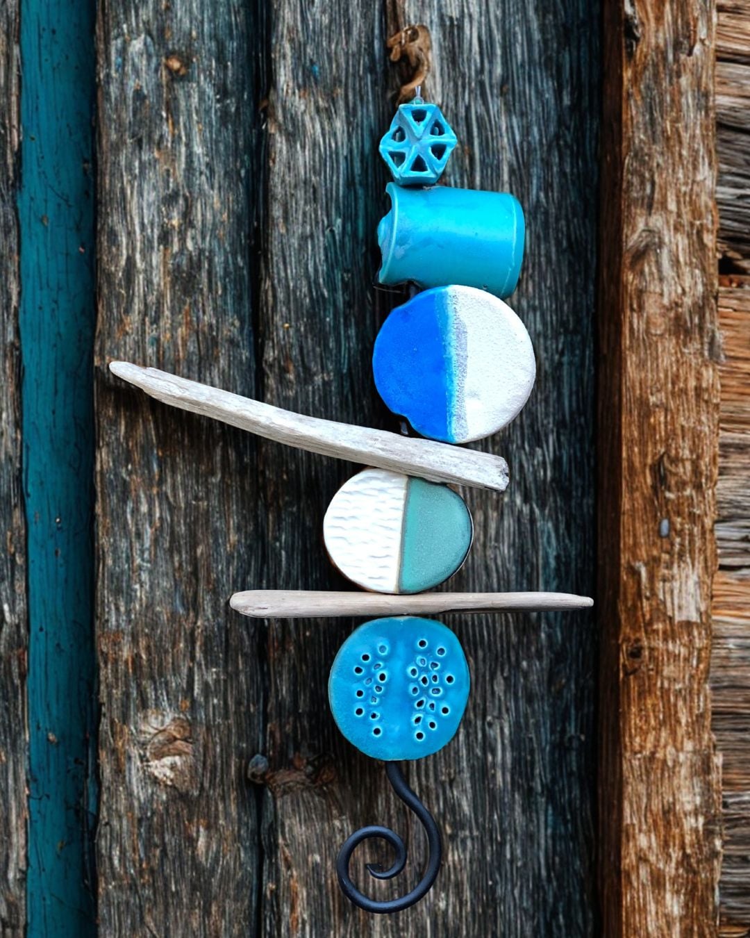 Tidelines, a mixture of ceramics and driftwood assembled on a metal rod