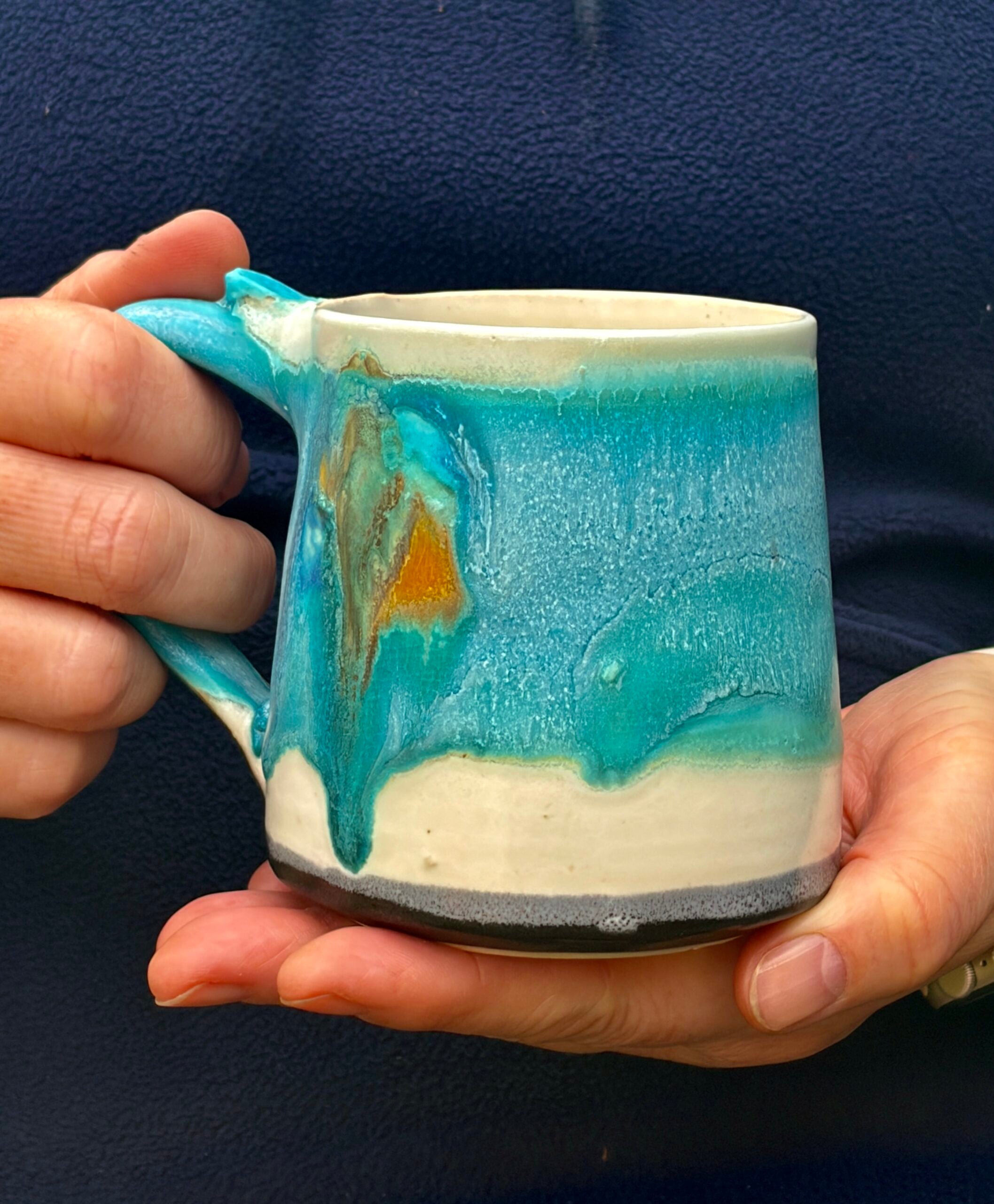 Holding a small Ocean mug