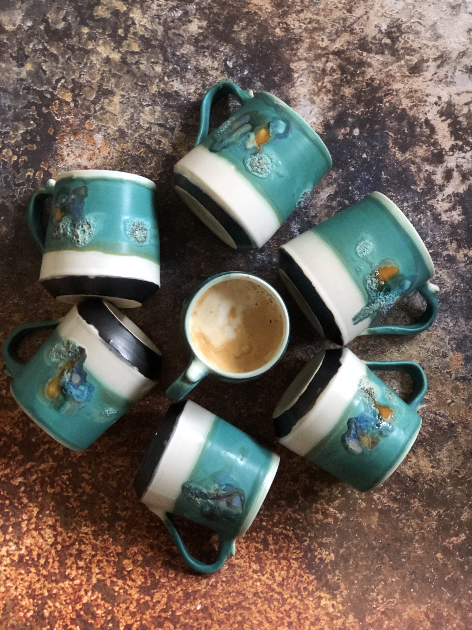Small mugs in Ocean design, glazed in a ocean-blue colour with accents of matte, glossy, and textured glazes, complemented by a crisp white liner glaze inside.