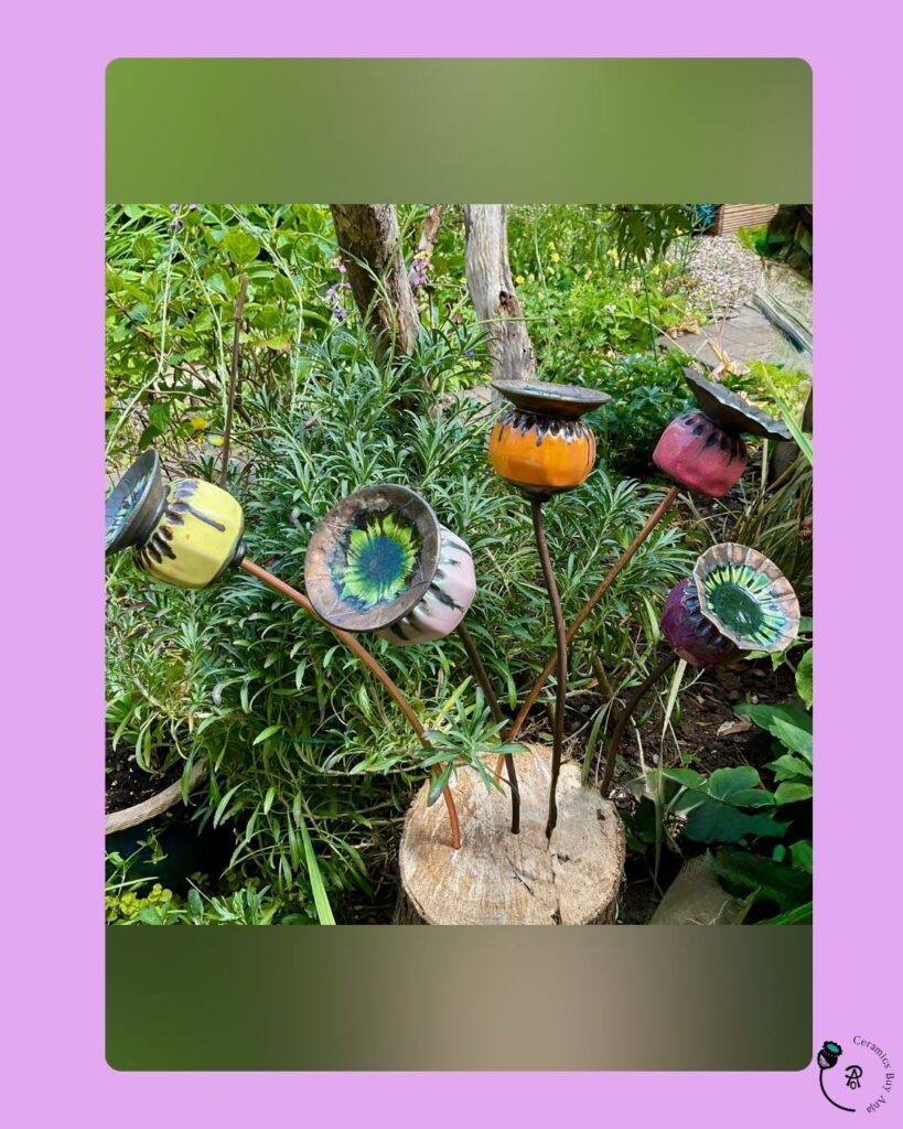 Ceramic poppy seed heads arranged at different heights in a wooden log.