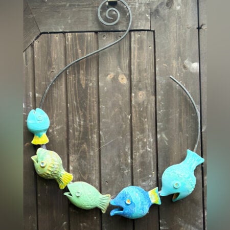 Wall hanging art: The fish catcher, five ceramic fish on a metal hoop with decorative scroll